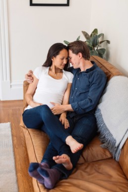 Young Mixed Race Blended Couple Pregnant Woman Snuggling in Home by San Francisco Family Photographer