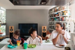 Young Interracial International Blended Siblings Eating Breakfast Together at the Counter in Modern Home by San Francisco Family Photographer